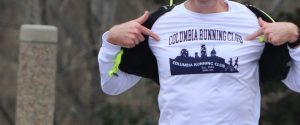Runner point to shirt that reads "Columbia Running Club"